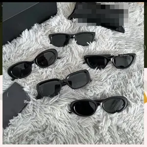Flat lay of five black y2k cyberpunk sports sunglasses on a grey plush background