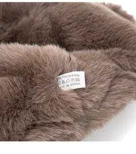 Close-up of the care label and brown faux fur texture of the polyester aviator hat