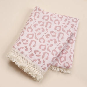 Soft cotton newborn swaddle blanket with pink leopard print and tassel edges.