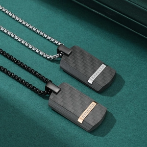 Men's carbon fiber dog tag necklaces in black and silver finishes on textured background