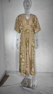 Detailed view of bohemian floral print on deep V-neck maxi dress with butterfly sleeves