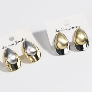Minimalist gold and silver teardrop earrings with brushed metal finish on white cards