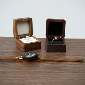 Detail of walnut wood jewelry box with thick black foam lining for ring storage