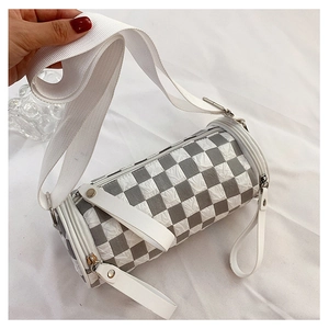 Detail of checkered cylinder crossbody bag with wide canvas strap and dual zippers