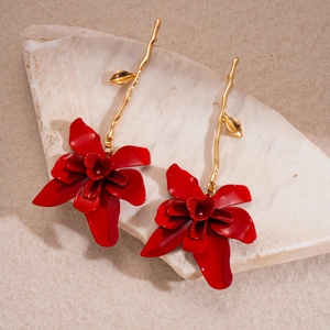 Detail of red flower earrings with gold leaves on stone base, vintage long design