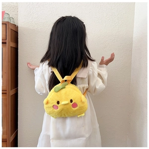 Detail of yellow plush cartoon chicken backpack with a green sprout and soft straps