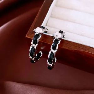 Luxury silver-tone chain earrings with woven black leather and sparkling star crystal