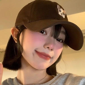 Casquette de baseball marron vintage avec chat brodé portée par un mannequin en gros plan