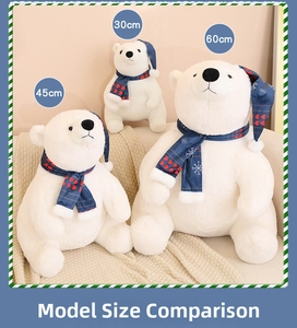 Three sizes of Christmas polar bear plush toys with festive scarves and hats on a sofa