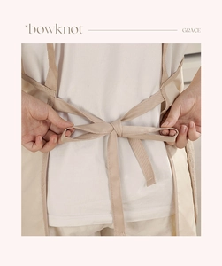 Detail of beige waterproof apron featuring adjustable back ties with a neat bowknot finish
