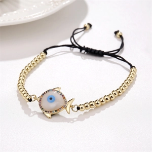 Macro shot of fish-shaped evil eye bracelet with colorful zircons and adjustable black cord