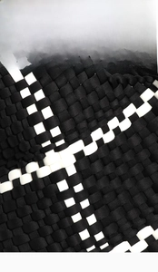 Detailed close-up of high-quality black and white woven texture on a tote handbag