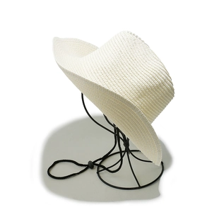 Close-up of a white woven cowboy straw hat featuring an adjustable black windproof chin strap