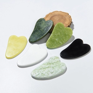 Detailed collection of heart-shaped jade gua sha tools in various natural stone colors