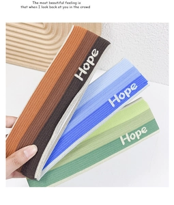 Detailed view of three-pack ribbed knit gradient headbands with Hope embroidery