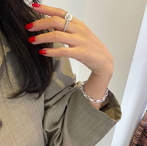 Close-up of irregular textured S925 sterling silver ring worn by a model on finger