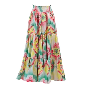 Detail of high-waisted bohemian maxi skirt with colorful tie-dye patterns and ruffled layers