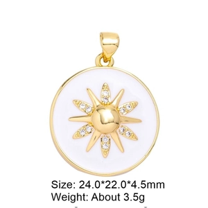 Detail view of gold sun pendant with white enamel and sparkling zircon inlay