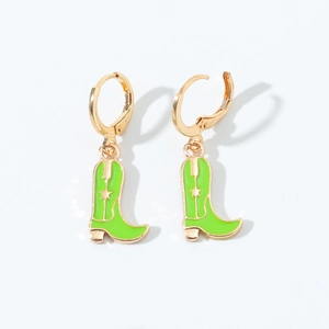 Detailed close-up of green enamel cowboy boot earrings with a golden star on white background