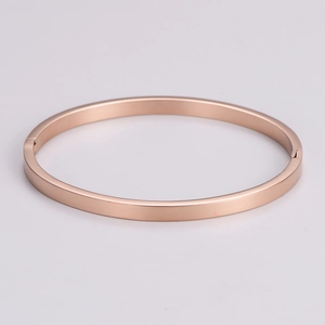 Detailed side view of rose gold oval bangle with hinge closure and smooth finish