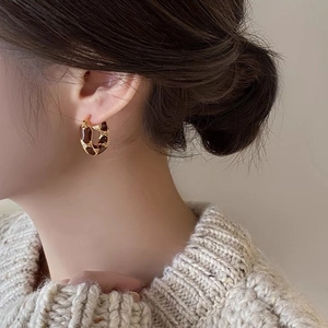 Vintage 14k gold plated tiger eye hoop earrings shown on a model with beige knitwear