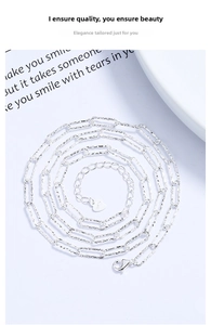 Macro detail of S925 sterling silver paperclip chain with lobster clasp and heart tag
