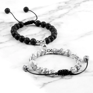 Close-up of magnetic heart clasp on volcanic stone and marble bead couple bracelets