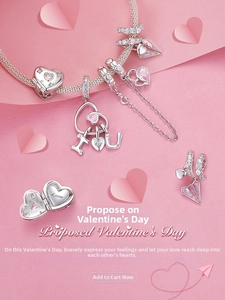 Macro detail of S925 silver charm bracelet with pink zircon heart and Love pendant