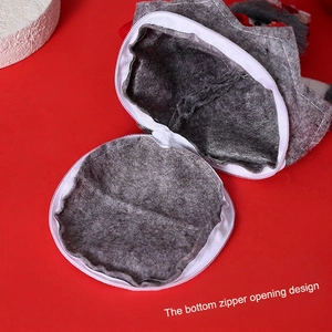 Grey Christmas felt gift bag featuring a Santa doll and a functional bottom zipper closure