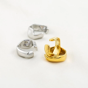 Irregular geometric gold and silver ear cuffs in minimalist punk style metal design