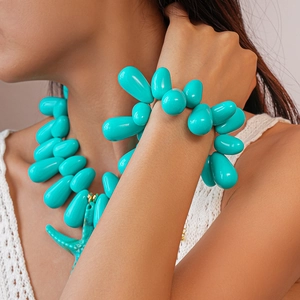 Close-up of Bohemian turquoise beaded necklace and bracelet with starfish pendants on model