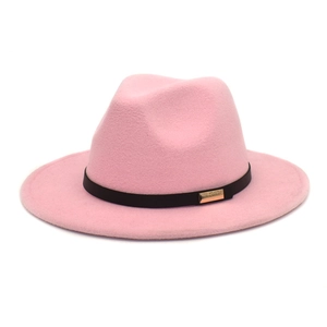 Close-up of pink wool fedora hat with black ribbon band and a gold metal buckle detail