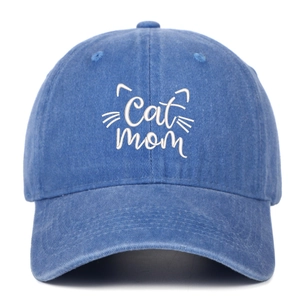 Close-up of white Cat Mom embroidery on navy blue washed denim baseball cap