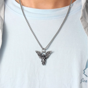 Close-up of a silver 3D guardian angel pendant with box chain on a model's neck
