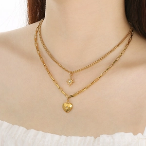 Double-layered gold titanium necklace with star and heart pendants worn by a model