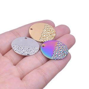 Polished and hammered stainless steel round pendants in gold, silver, and rainbow tones