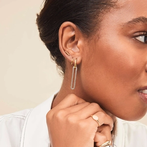 Two-tone 18K gold and silver stainless steel detachable long earrings shown on a model