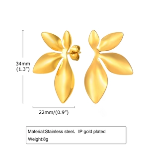 Detailed view of 18K gold-plated leaf earrings with 34mm height and 22mm width dimensions