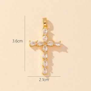 Detailed view of a gold-plated cross pendant with clear zircons, measuring 3.6cm by 2.1cm