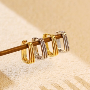 Close-up of gold and silver S925 sterling silver geometric rectangular hoop earrings