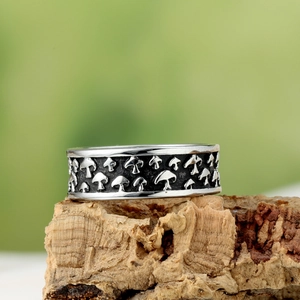 Retro mushroom embossed silver ring for men in stainless steel on wooden background