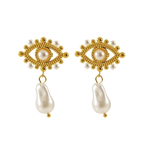 Detailed view of gold evil eye earrings with white pearls on a clean background