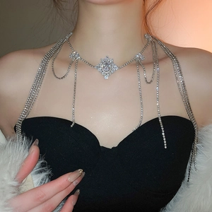 Detail view of a luxury silver rhinestone body chain with multi-layered tassels