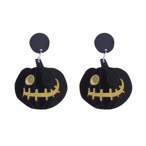 Detail of Halloween black acrylic pumpkin earrings with contrasting yellow facial expressions
