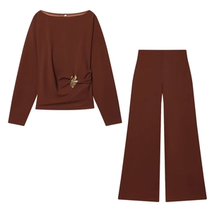 Detail of brown long sleeve top with waist metal ring and matching wide leg pants