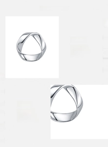Detail macro view of polished s925 silver stud earrings with a sleek wavy metal texture