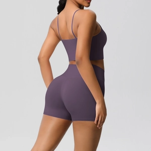Detail view of deep purple yoga set with high waist shorts and thin strap sports bra