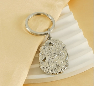 Détail d'un porte-clés en argent avec relief de dragon chinois sur soie élégante