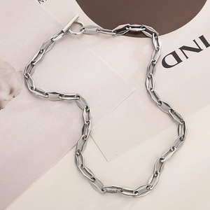 Detail of silver titanium steel necklace with geometric links and OT toggle clasp