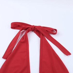 Detail of red halter neck top showing adjustable tie-back design and fabric texture